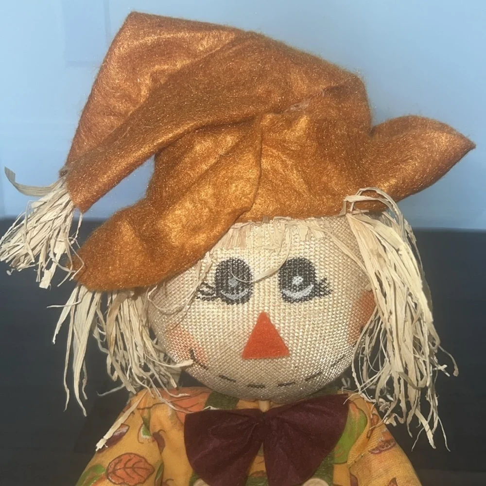 Scarecrow figurine with straw Bale